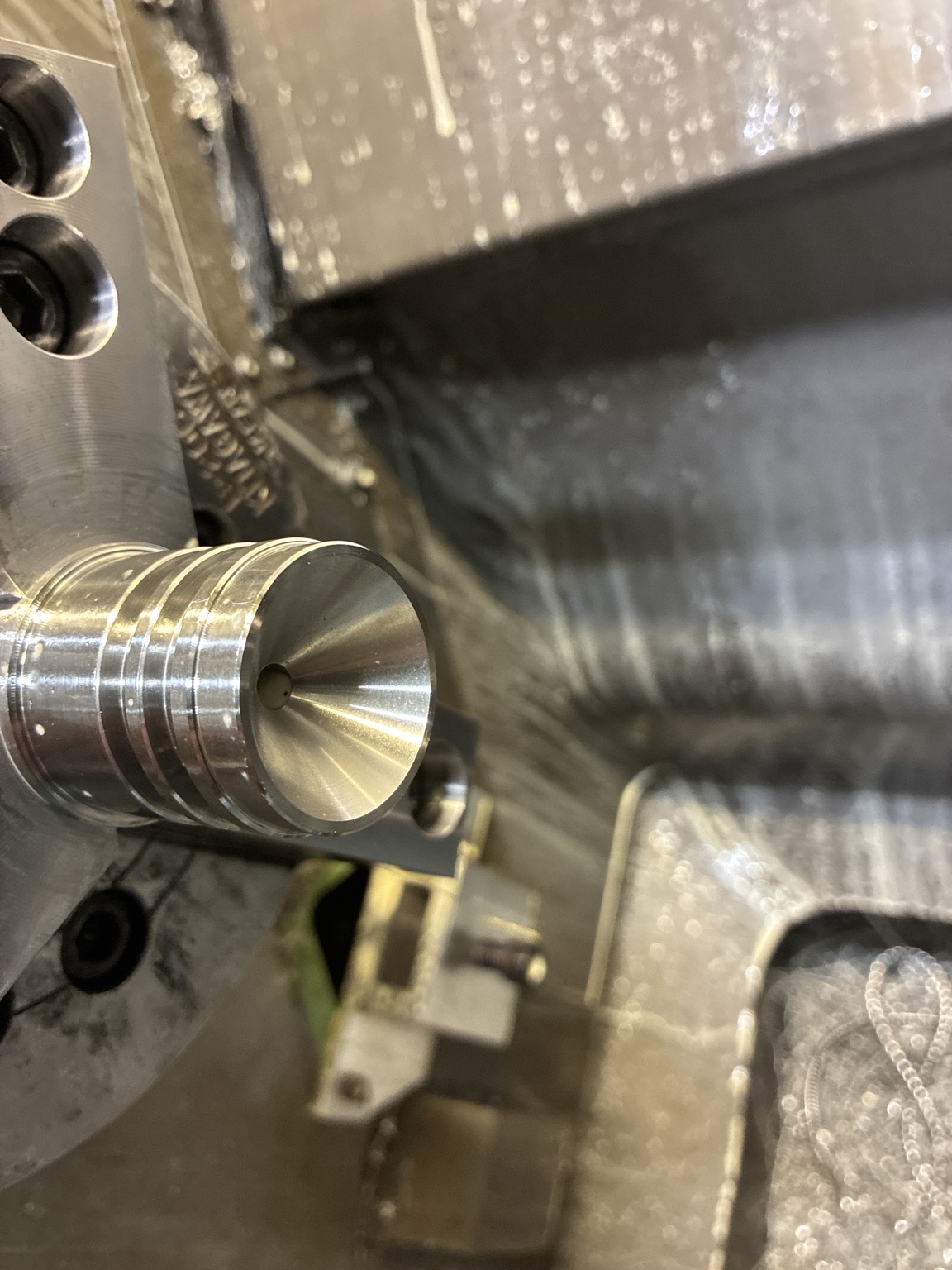 316 stainless component in a lathe chuck showing grooves and an internal profile