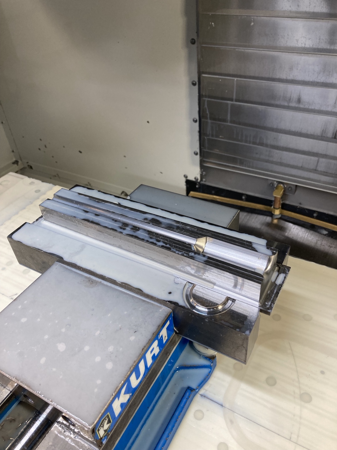 Machined contours and surfaced features on a part held in a milling vise